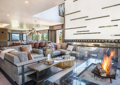 The sitting area with fireplace at Luxury ski-in ski-out chalet for large group chalet Perce Neige for 14 adults and 4 children with pool and a chef to rent in Courchevel 1850 with In-Luxe Chalets France