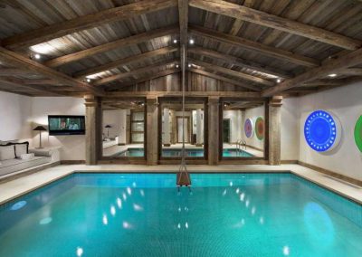 Indoor swimming pool at Luxury Chalet Grande Roche Courchevel 1850, for 14 people with fitness, sauna, steam room, outdoor jacuzzi, cinema, massage room and a chef; Chalet rental Courchevel 1850 with In-Luxe Chalets France